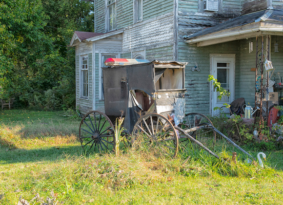 Abandoned police buggy in front of abandoned house - eric reidinger